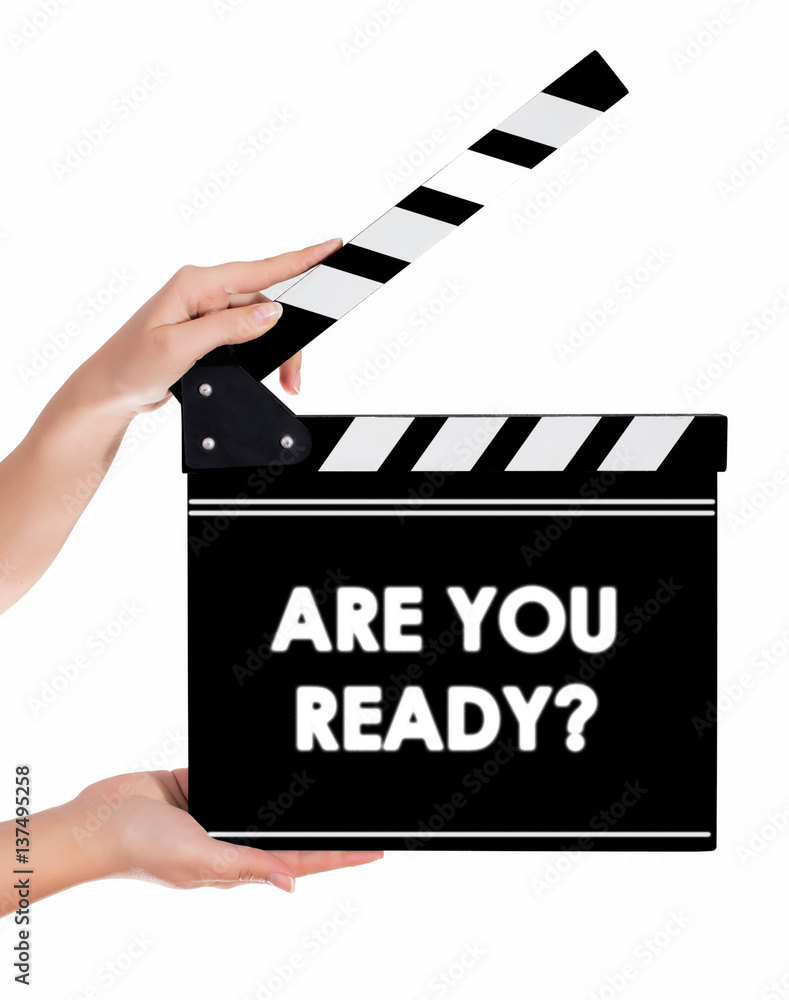 Hands holding a clapper board with ARE YOU READY text