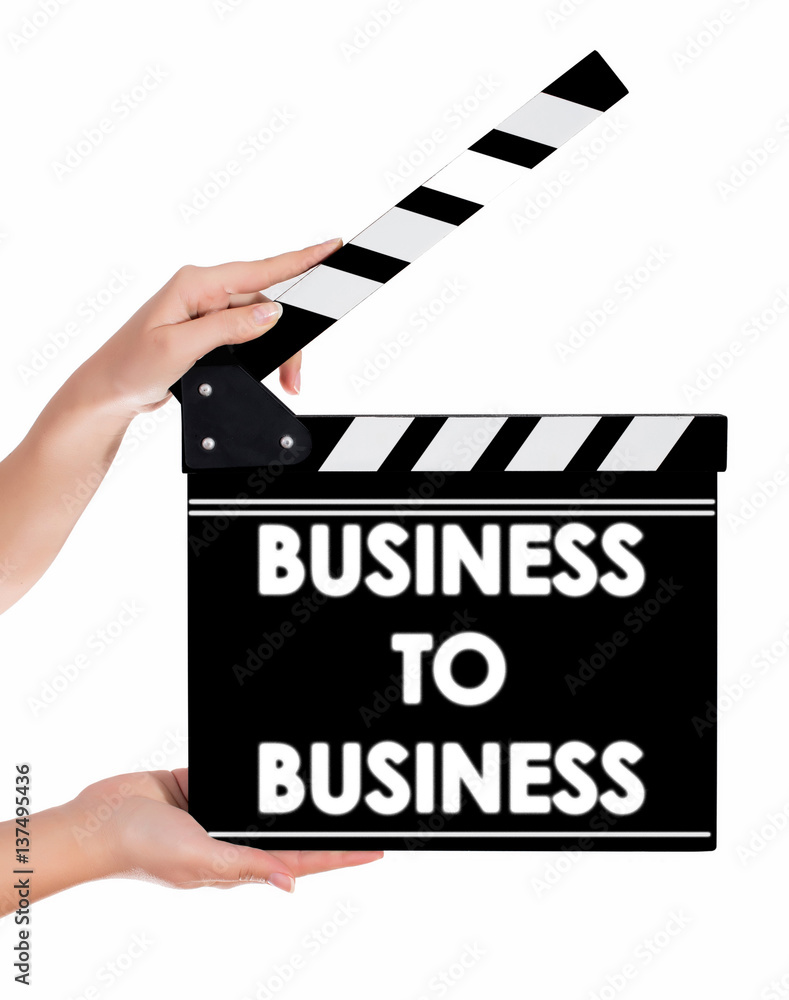 Hands holding a clapper board with BUSINESS TO BUSINESS text