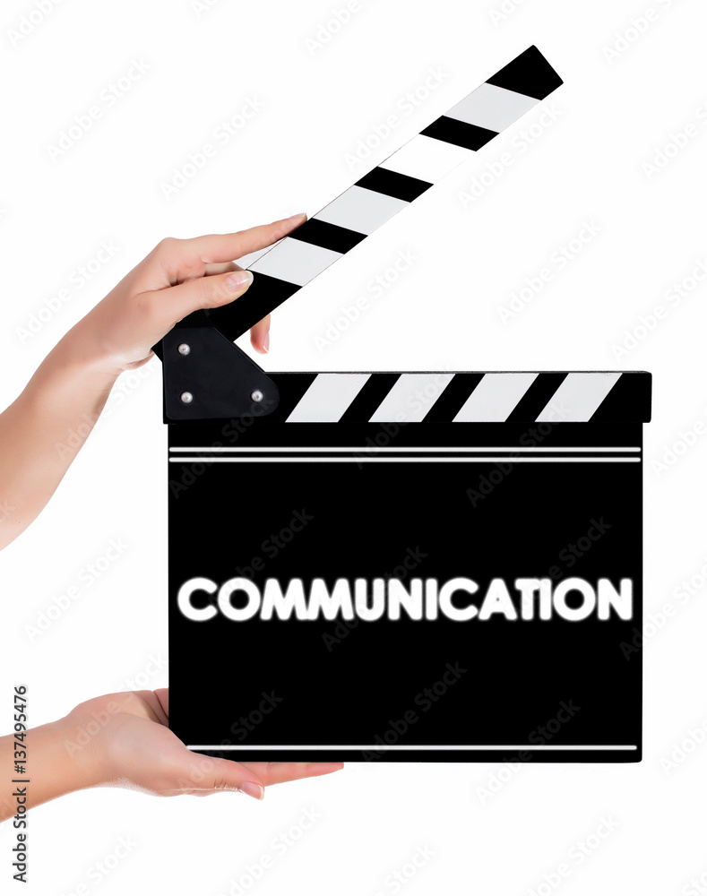 Hands holding a clapper board with COMMUNICATION text