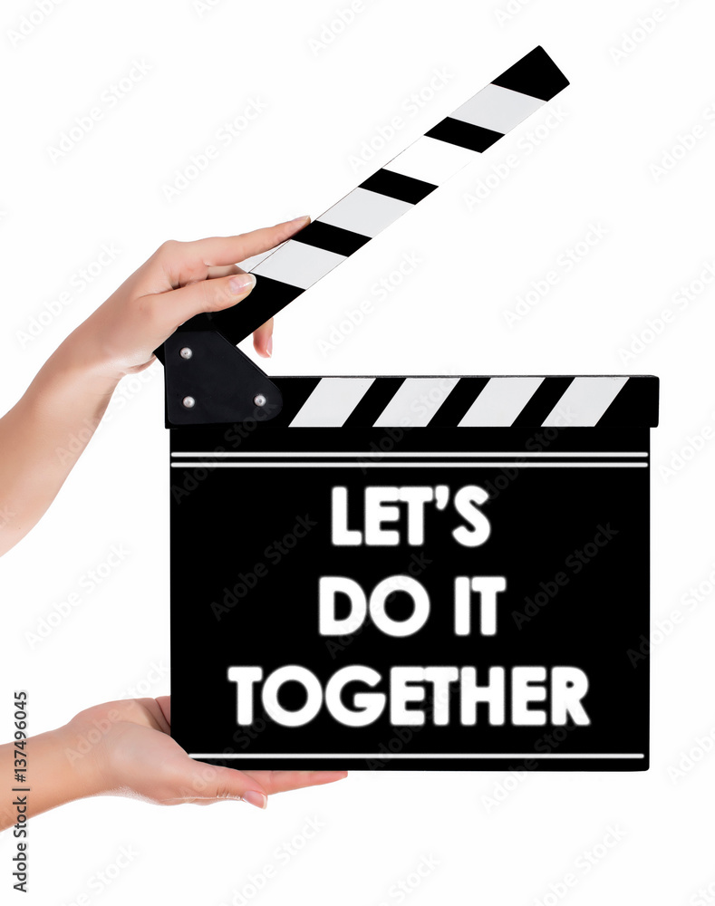 Hands holding a clapper board with LET'S DO IT TOGETHER text Stock