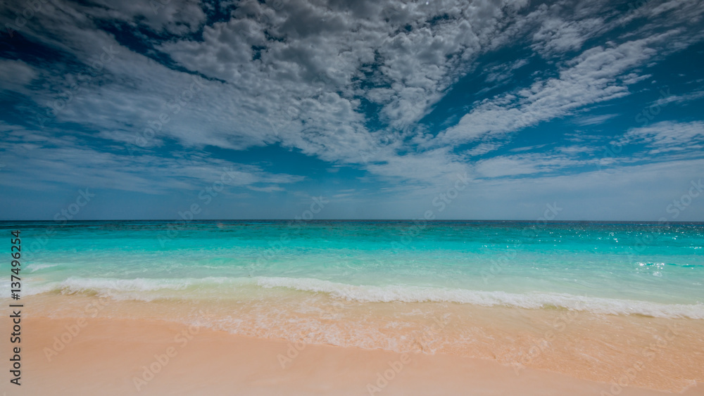 Tranquil turquoise sea sand beach and cloud blue sky scenery background. 
