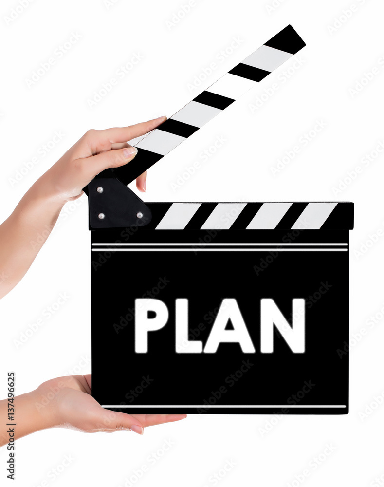 Hands holding a clapper board with PLAN text