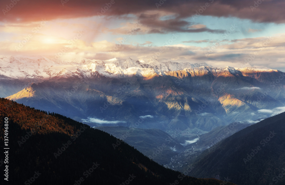 Fantastic snow-capped mountains in the beautiful cumulus clouds.