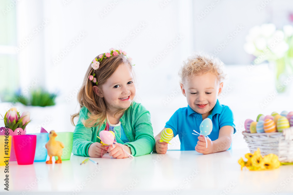 Fototapeta premium Kids with colorful Easter eggs on egg hunt