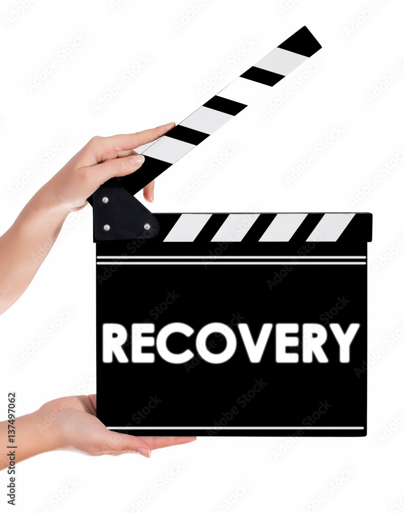 Hands holding a clapper board with RECOVERY text