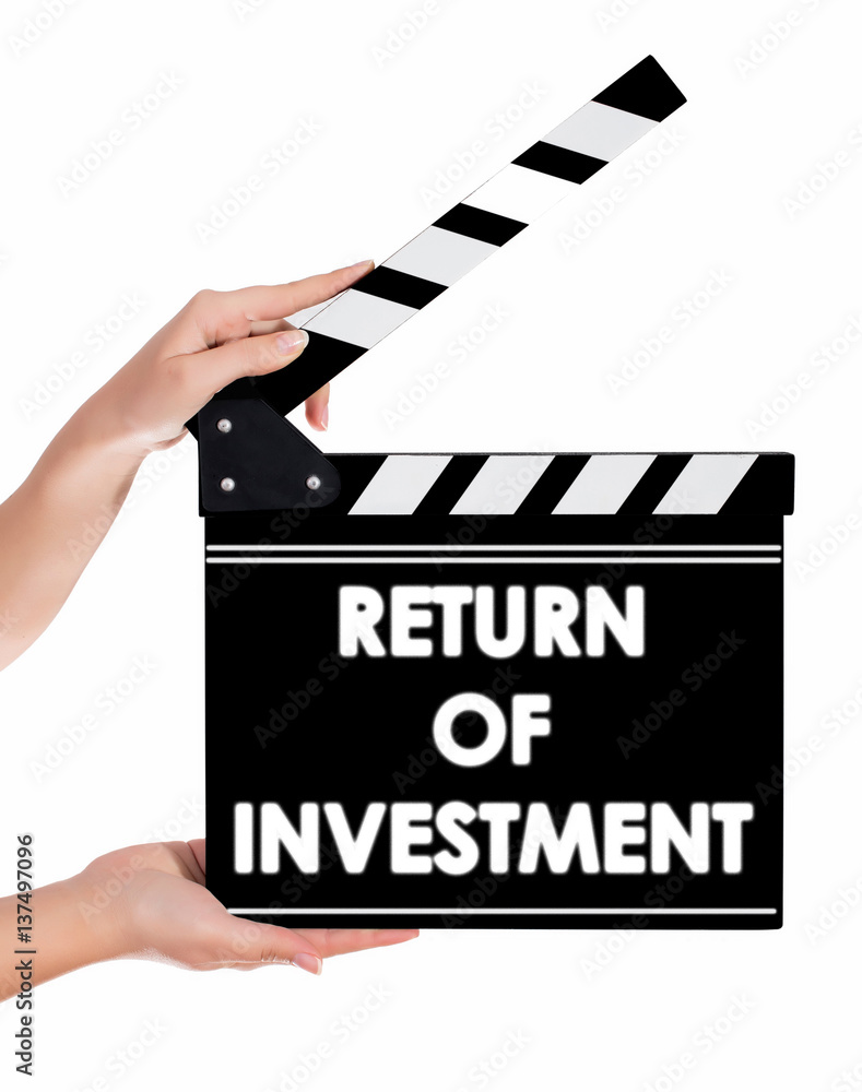Hands holding a clapper board with RETURN OF INVESTMENT text