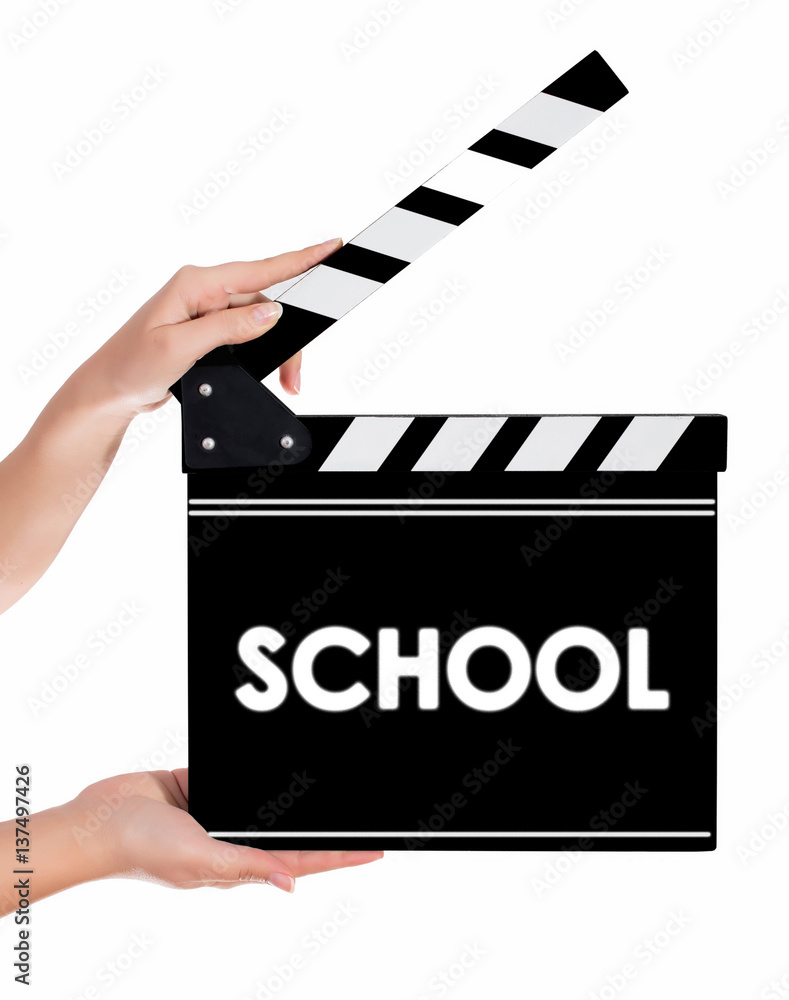 Hands holding a clapper board with SCHOOL text