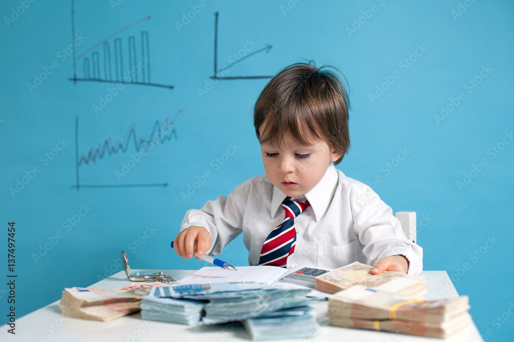Young boy, counting money and taking notes Young boy, counting money and taking notes