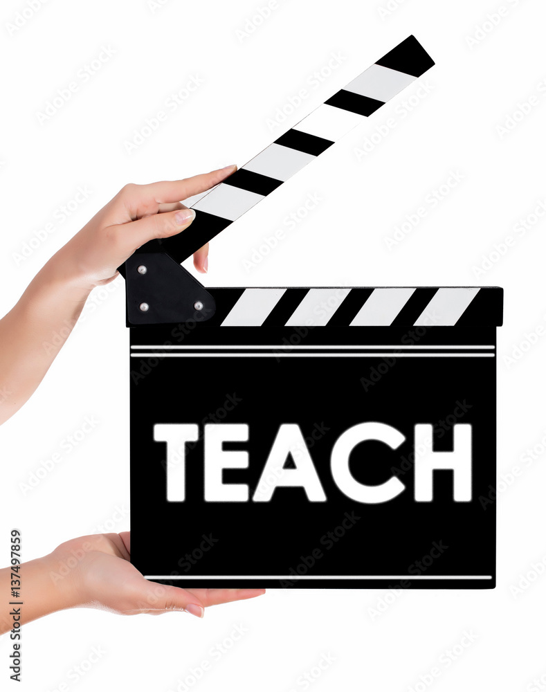 Hands holding a clapper board with TEACH text