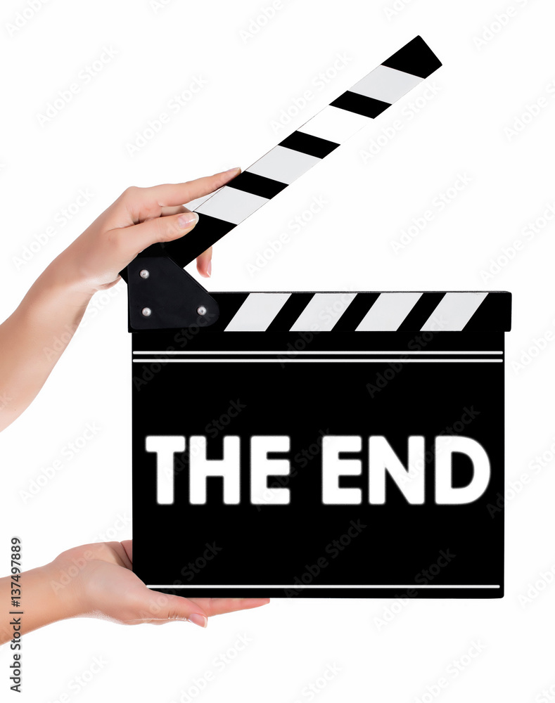 Hands holding a clapper board with THE END text
