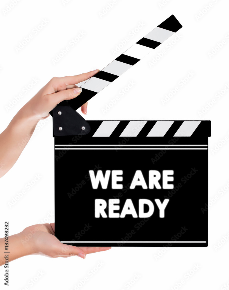 Hands holding a clapper board with WE ARE READY text