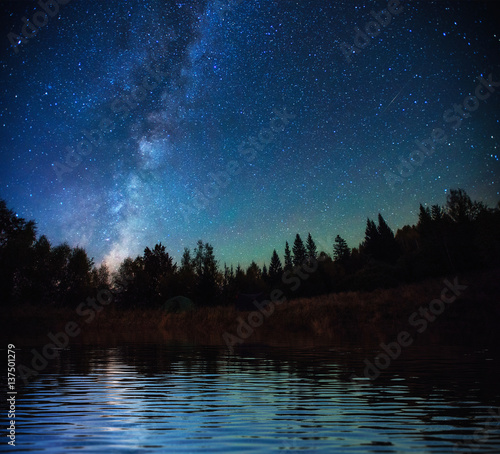 Starry sky over the sea. Fantastic Milky Way. Meteor shower
