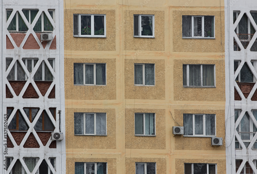 Fototapeta premium Vintage background wall with windows of a multistory building