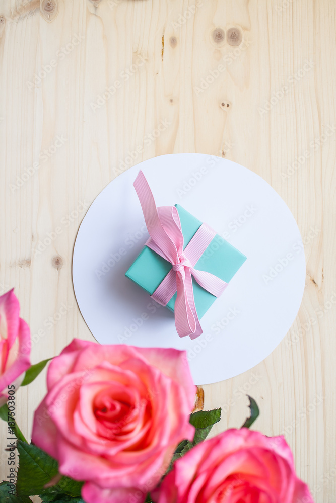 gift and three roses on white background gift and three roses on white background