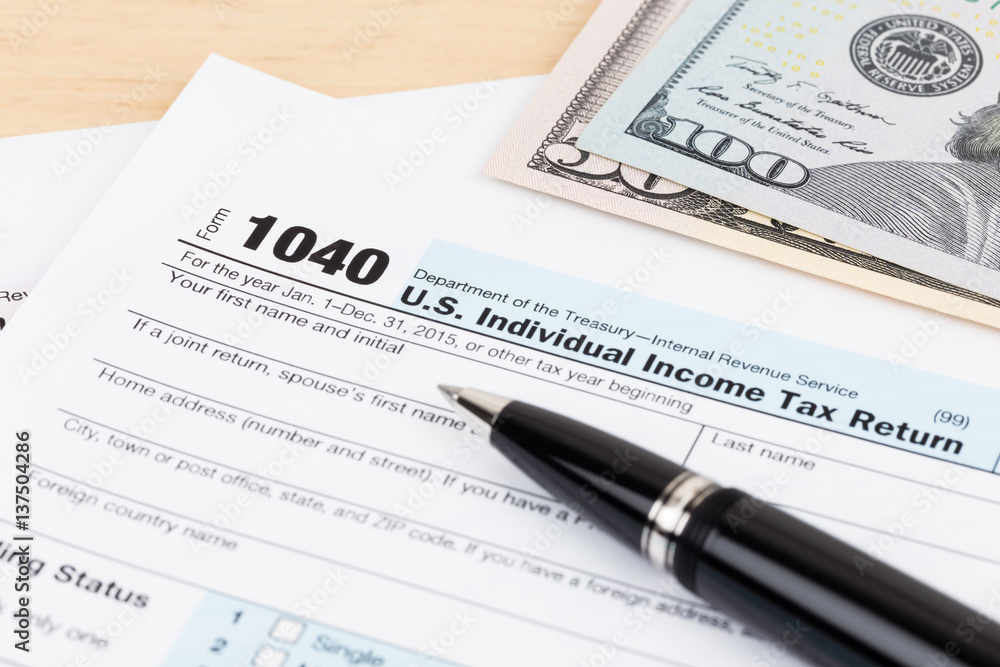 Tax form with pen, and dollar banknote Tax form with pen, and dollar banknote