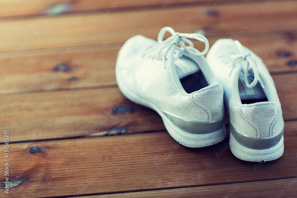 close up of sneakers on wooden floor close up of sneakers on wooden floor