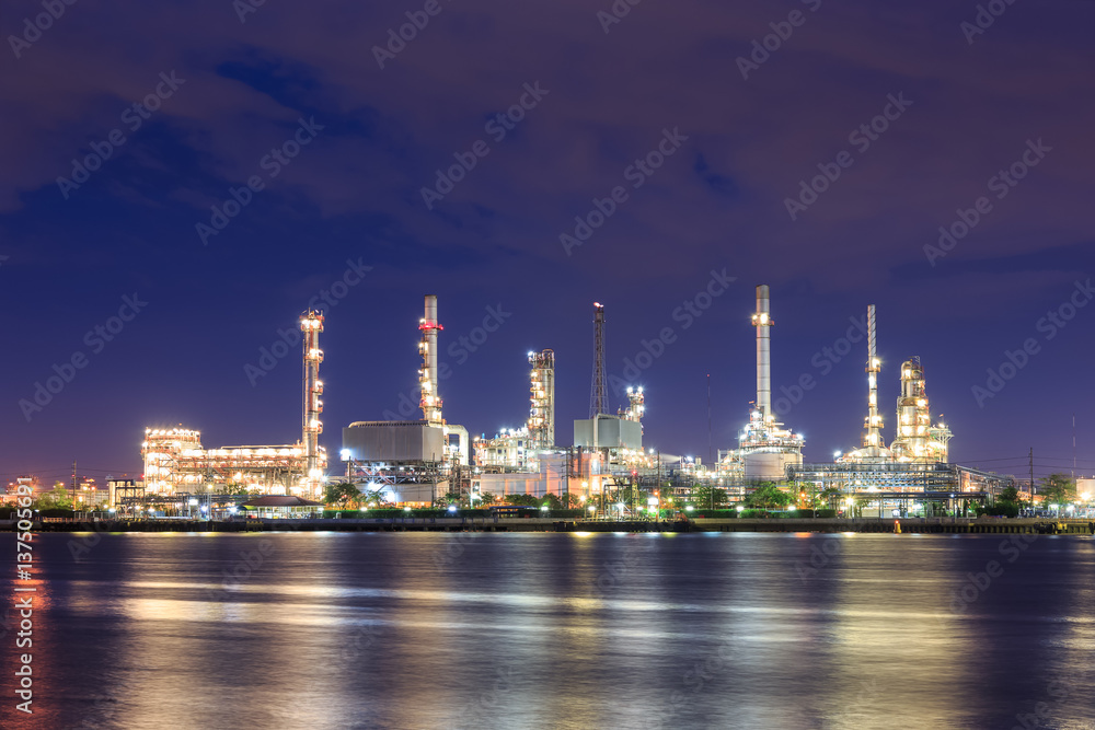 Oil refinery on water front at night Oil refinery on water front at night