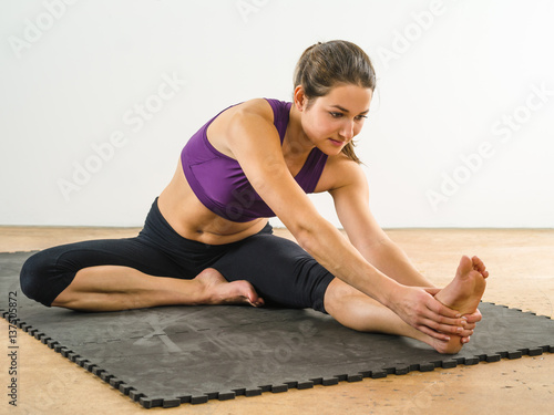 Young woman stretching her leg