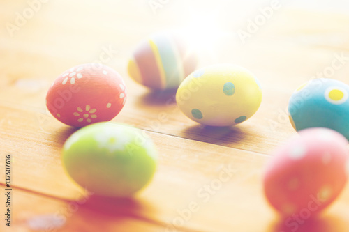 close up of colored easter eggs on wooden surface