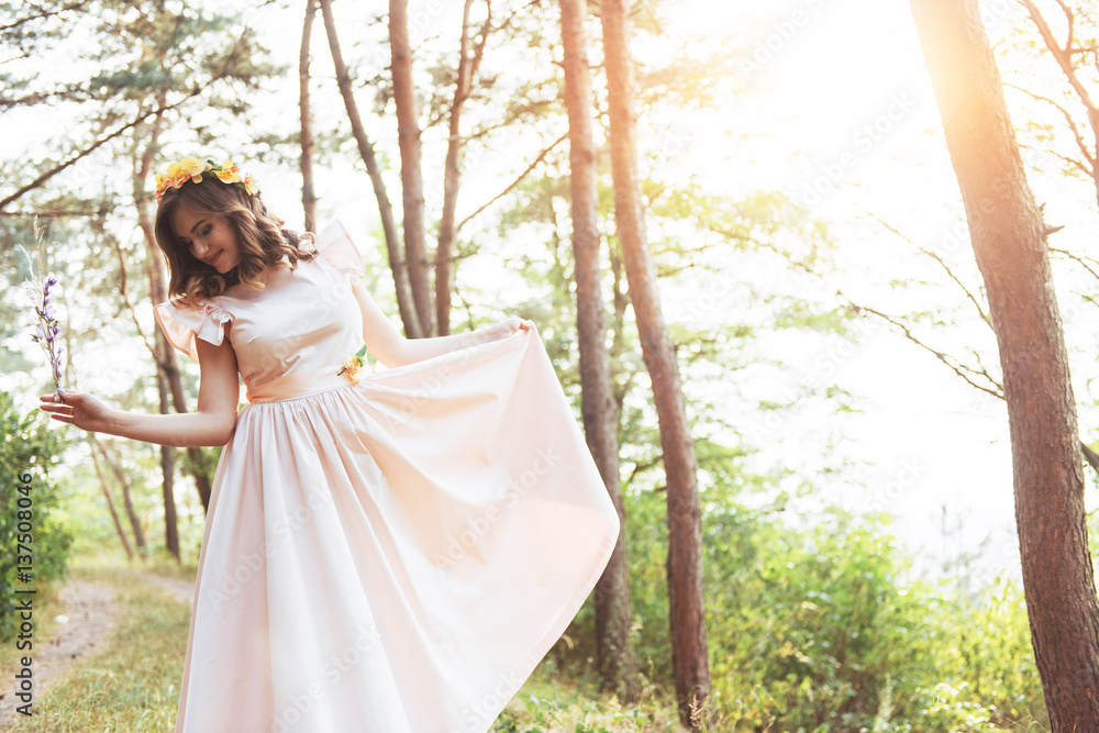 Happy young woman in long dress a beautiful pine forest Happy young woman in long dress a beautiful pine forest