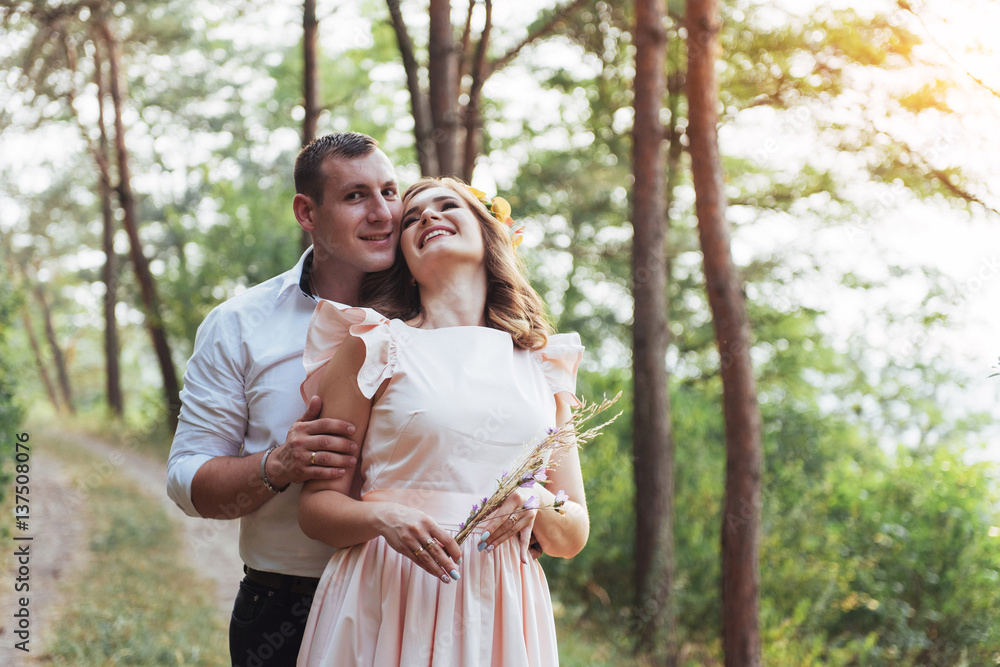 Fototapeta premium Walk a happy young couple on the nature