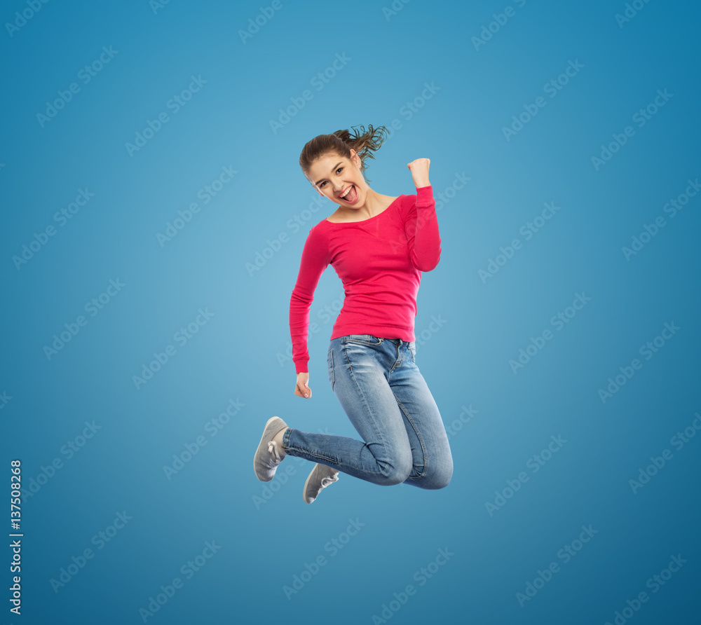 Obraz premium smiling young woman jumping in air