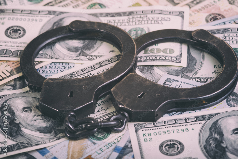 Dollars and handcuffs. Financial crime, illegal activity