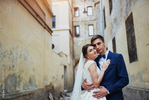 Wedding portrait of a happy couple. Stand and kissing