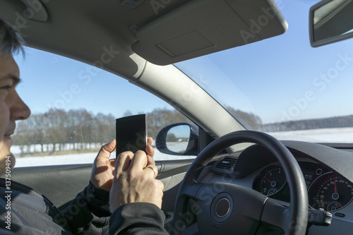 Man talking in the car with his mobile phone