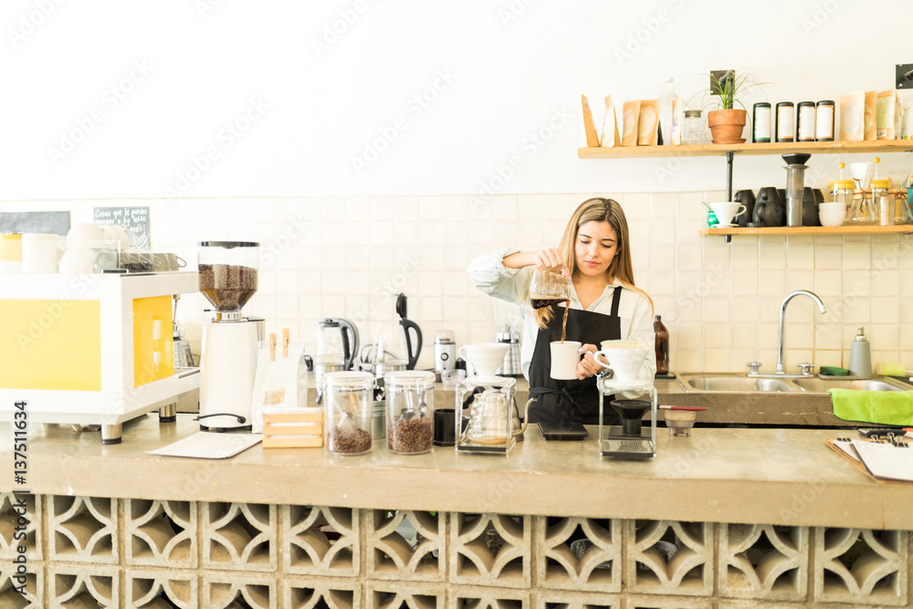 Cute barista working in a coffee shop Cute barista working in a coffee shop