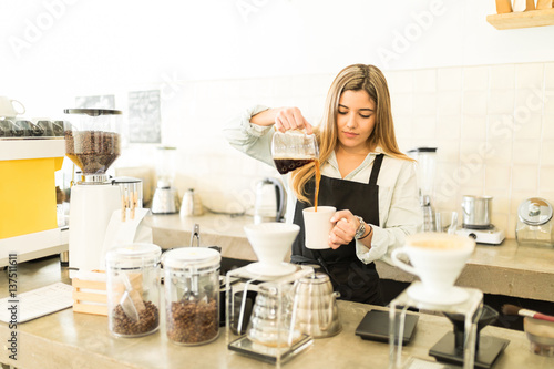 Barista pouring a cup of coffee