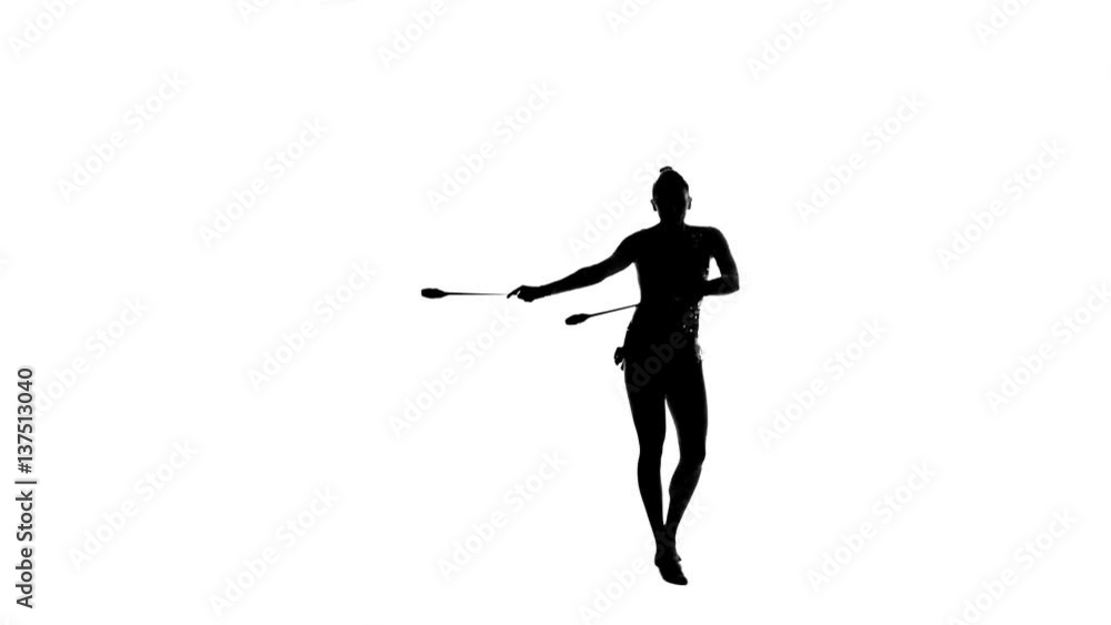 Gymnast holding a mace and makes artistic movement. White background. Silhouette Gymnast holding a mace and makes artistic movement. White background. Silhouette