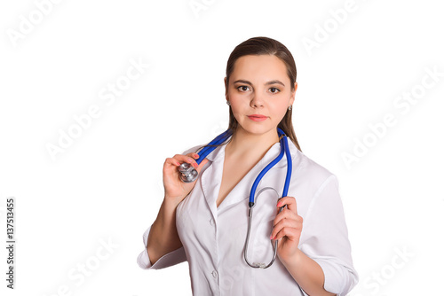 The doctor in a white coat with a stethoscope around his neck. Doctor nutritionist brunette on a white background isolation. Nurses with stethoscope. © Ilias