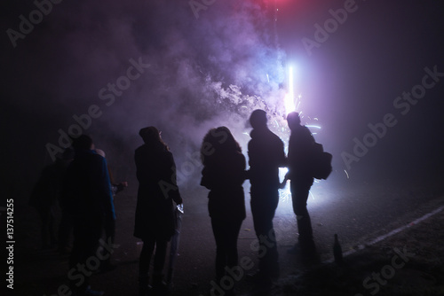 people standing and watching fireworks, silvester, dark, silhouette