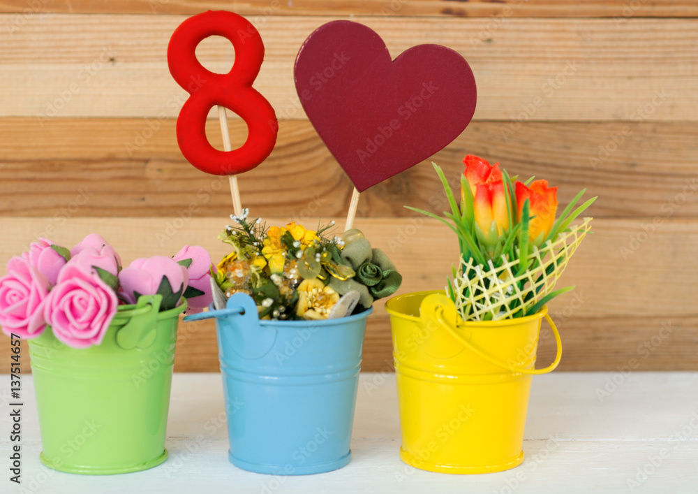 lollipop  shape figure eight 8, note for text, flowers in colored buckets. Happy International Women’s Day celebrate on March 8, congratulatory CARD. 