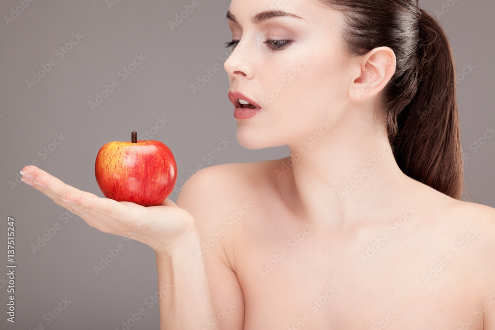 Portrait d'une jeune femme tenant une pomme dans sa main
