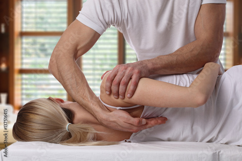 Photos Woman having chiropractic back adjustment