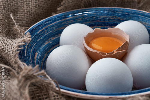 fresh eggs collected in the plate for cooking on the fabric. photo