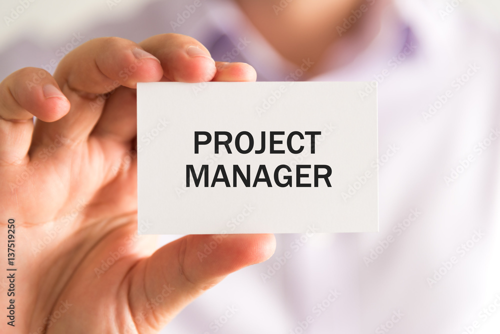 Businessman holding card with text PROJECT MANAGER Businessman holding card with text PROJECT MANAGER