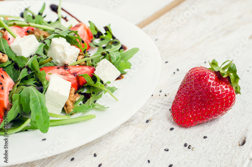 Fresh salad with arugula and strawberries