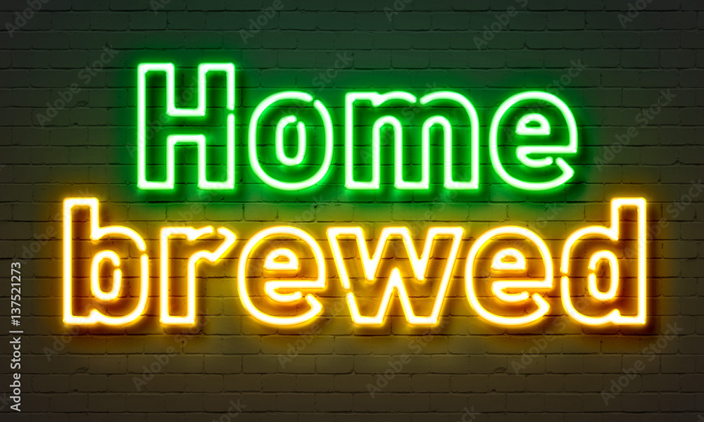 Home brewed neon sign on brick wall background.