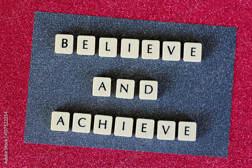 Bild auf Leinwand Believe and Achieve Letters On Grey and Pink Glitter Background