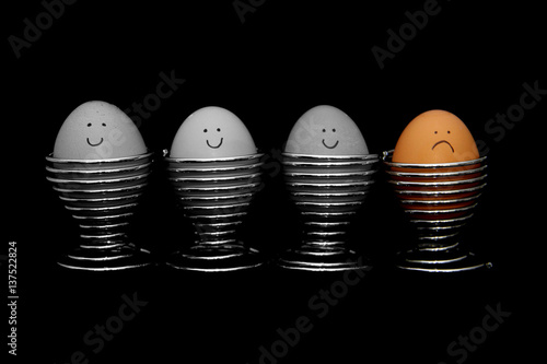 Four Eggs Lined Up, Unhappy Egg In Colour on Black Background 2