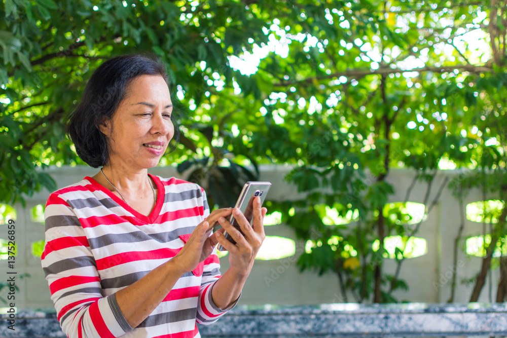 Middle-aged women playing telephone