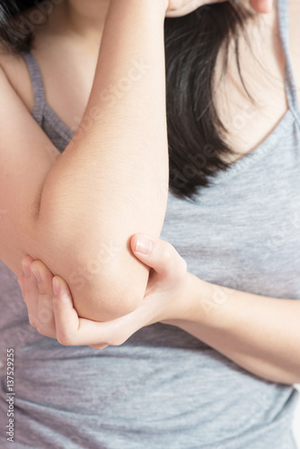 Wallpaper Mural Acute pain in a woman elbow isolated on white background. Clipping path on white background. Torontodigital.ca