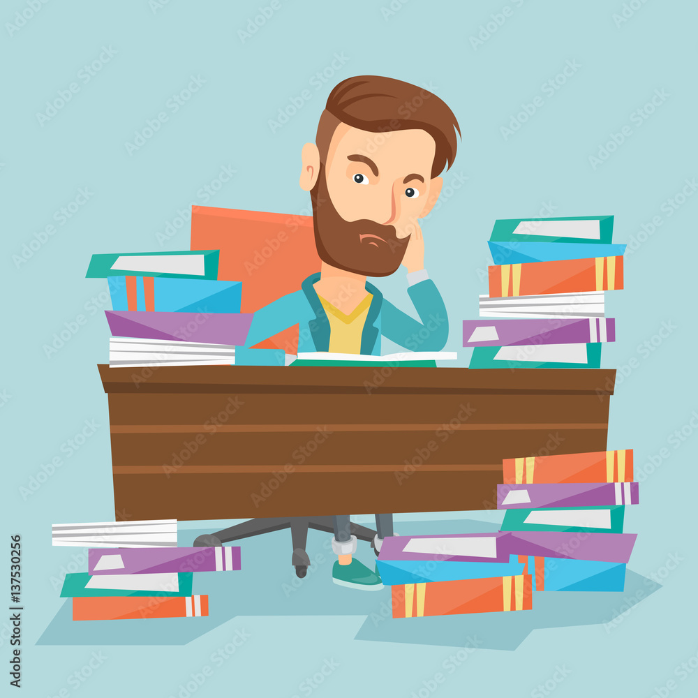 Student sitting at the table with piles of books.