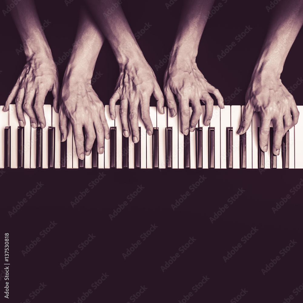 five hands playing on piano keys, black and white. music background