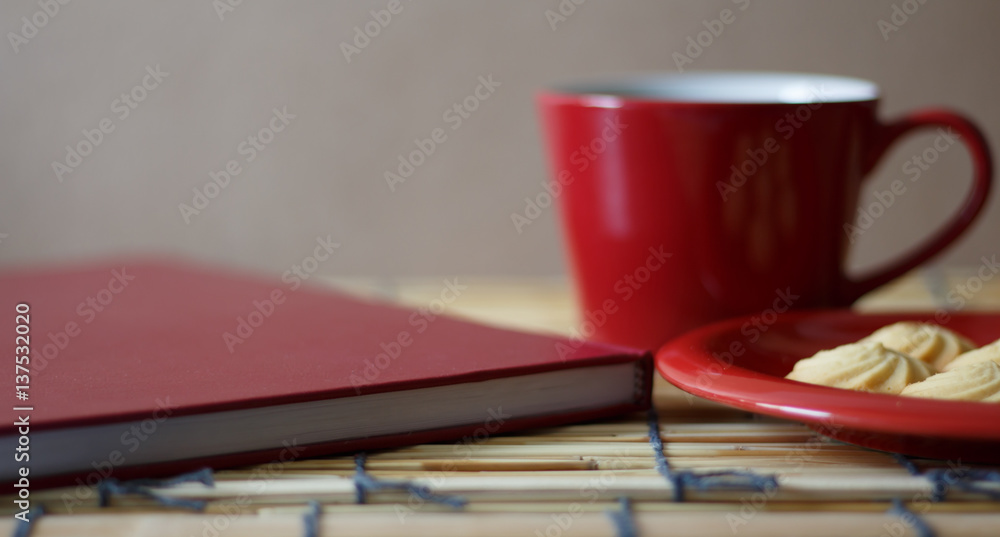 Hot coffee, cookies and a book on a wooden table. Hot coffee, cookies and a book on a wooden table.