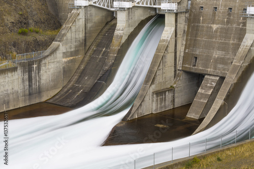 Water flowing from hydro dam spillway photo