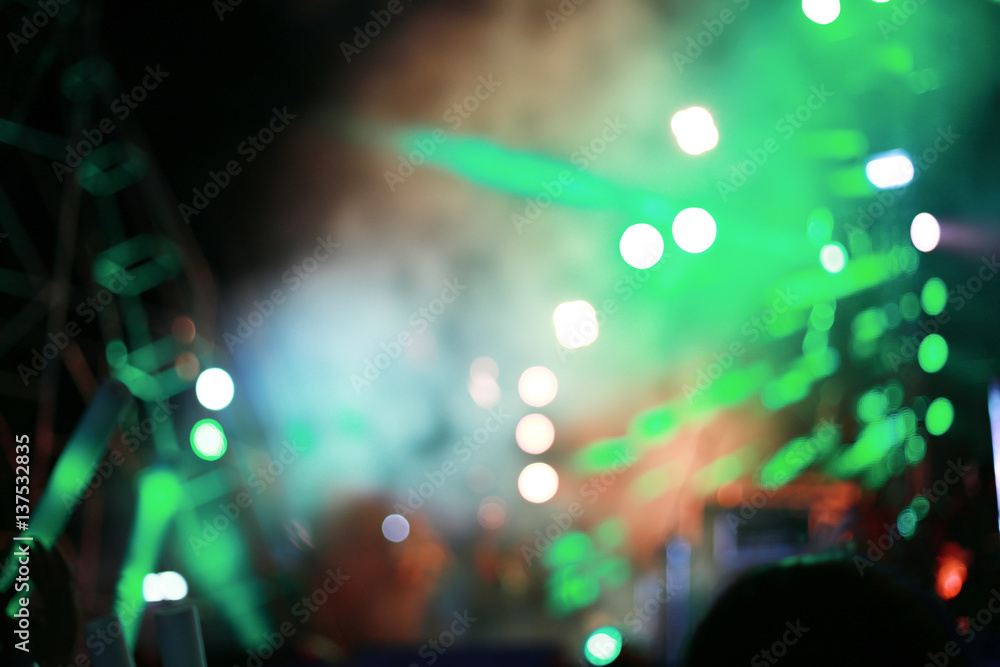 Blurred background concert : Bokeh lighting in concert with audience, Music showbiz concept, music performance concert with bokeh spotlight. entertainment concert lighting on stage, blur disco party